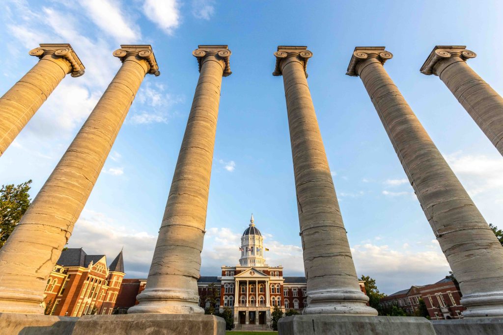 Jesse hall and columns against a blue sky