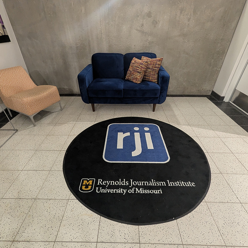 Floor rug with RJI graphic and Reynolds Journalism Institute signature.